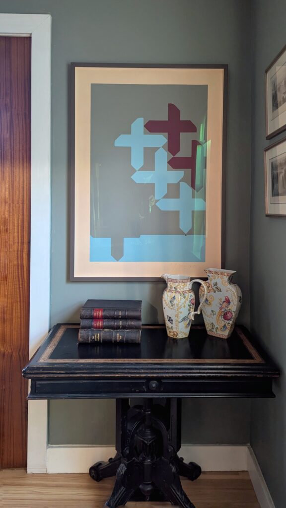 Framed Harold Town serigraph hanging in a room