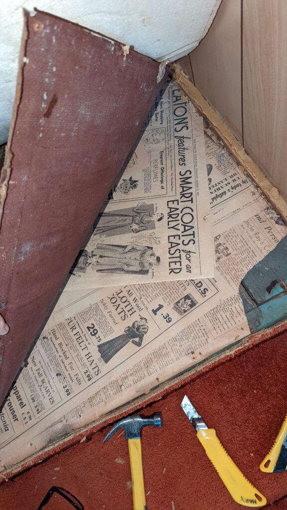 peeling back old flooring to show newspaper underlay from 1937